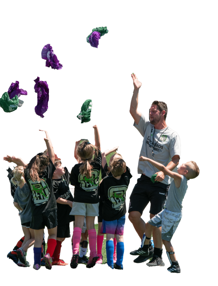 Sander from Phocus Soccer throwing jerseys in the air together with happy children